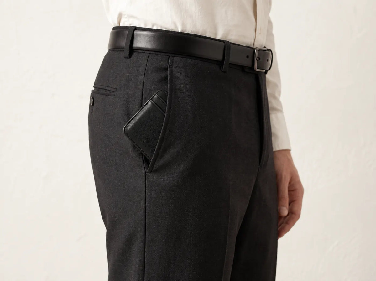 The Essential Wallet sitting flat in the front pocket of tailored trousers